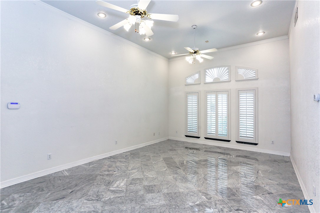 2110 Lakeview Loop Killeen, TX 76543 - Photo 13 of 42 an empty room with chandelier fan and windows