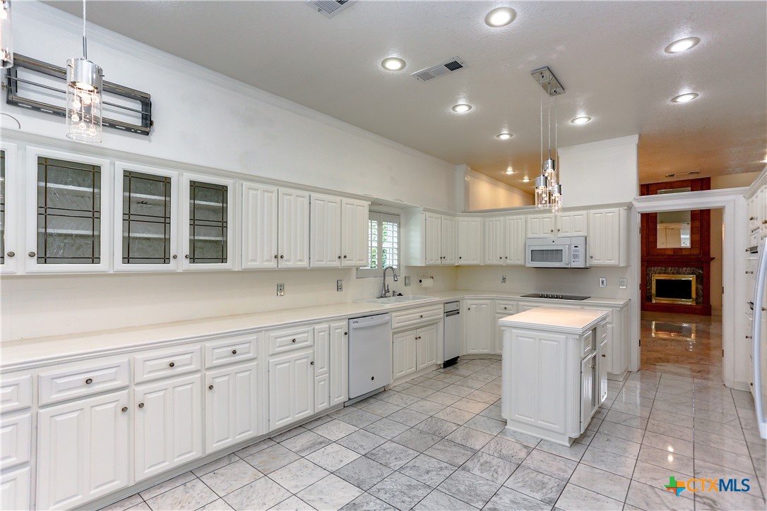 2110 Lakeview Loop Killeen, TX 76543 - Photo 23 of 42 a kitchen with white cabinets and sink
