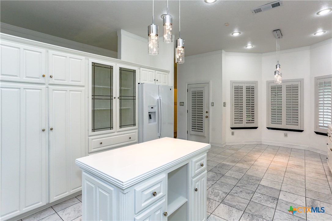 2110 Lakeview Loop Killeen, TX 76543 - Photo 25 of 42 a kitchen with kitchen island a chandelier stainless steel appliances cabinets and a counter top space