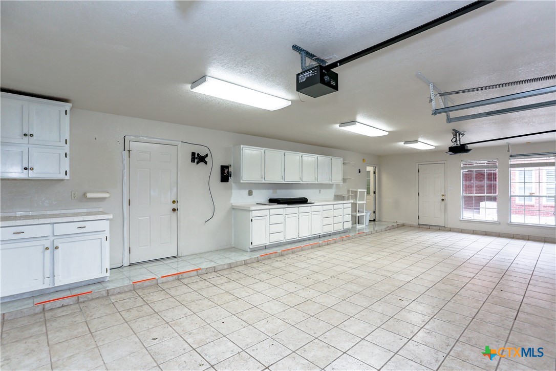 2110 Lakeview Loop Killeen, TX 76543 - Photo 35 of 42 a large white kitchen with cabinets and a stove top oven