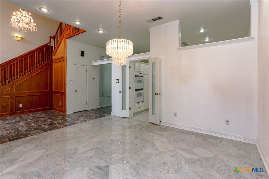 2110 Lakeview Loop Killeen, TX 76543 - Photo 9 of 42 a view of a room with a chandelier and kitchen view
