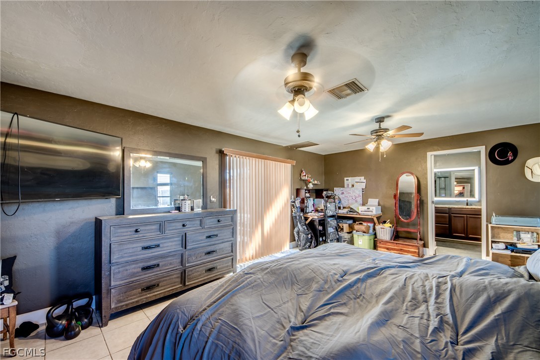 3015 8th Street Southwest Lehigh Acres, FL 33976 - Photo 14 of 34 a bed room with a bed and a television