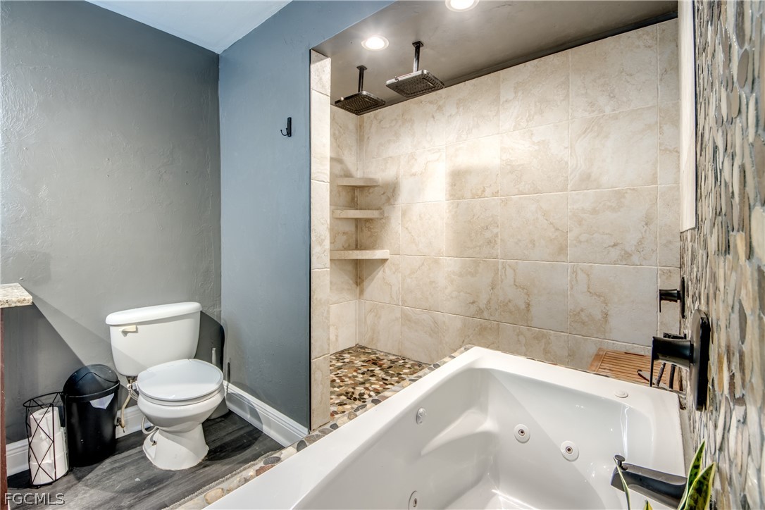 3015 8th Street Southwest Lehigh Acres, FL 33976 - Photo 19 of 34 a bathroom with a toilet and a shower