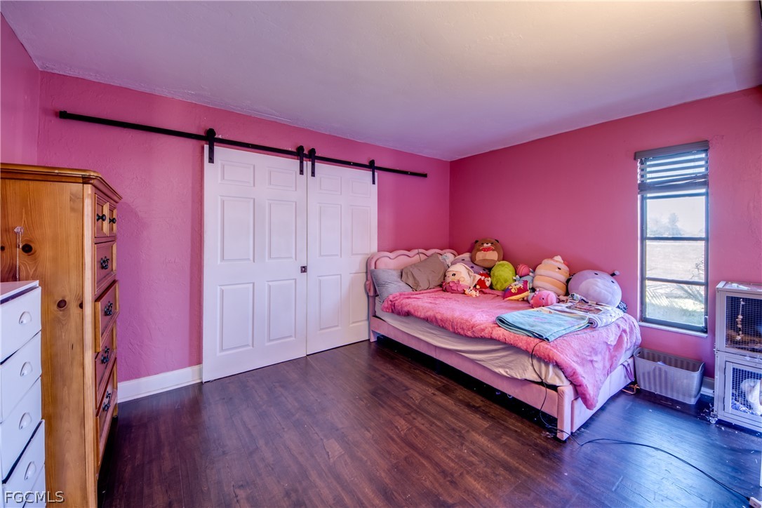 3015 8th Street Southwest Lehigh Acres, FL 33976 - Photo 20 of 34 a bedroom with a bed and a window