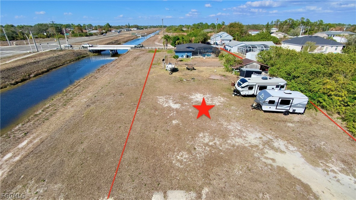 3015 8th Street Southwest Lehigh Acres, FL 33976 - Photo 2 of 34 an aerial view of a house with a garden and pool