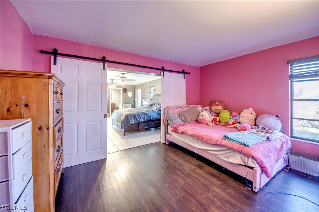3015 8th Street Southwest Lehigh Acres, FL 33976 - Photo 21 of 34 a bedroom with a bed and a couch