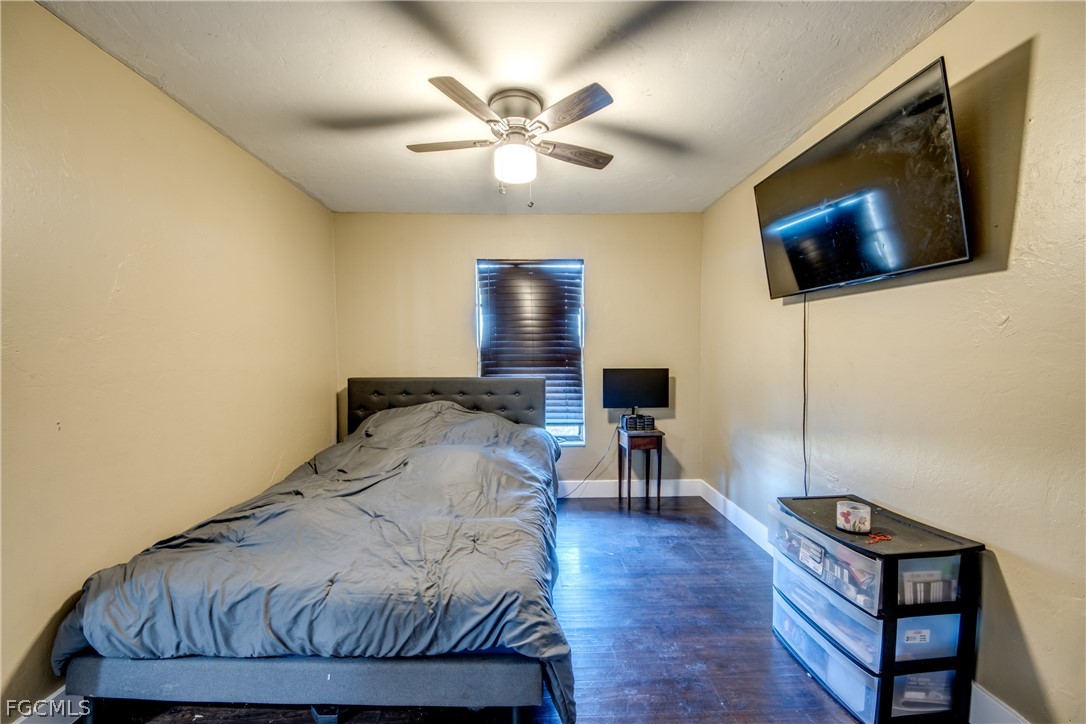 3015 8th Street Southwest Lehigh Acres, FL 33976 - Photo 22 of 34 a bedroom with a bed window and a flat screen tv