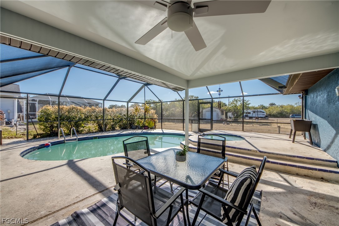 3015 8th Street Southwest Lehigh Acres, FL 33976 - Photo 25 of 34 a view of backyard with swimming pool and outdoor seating
