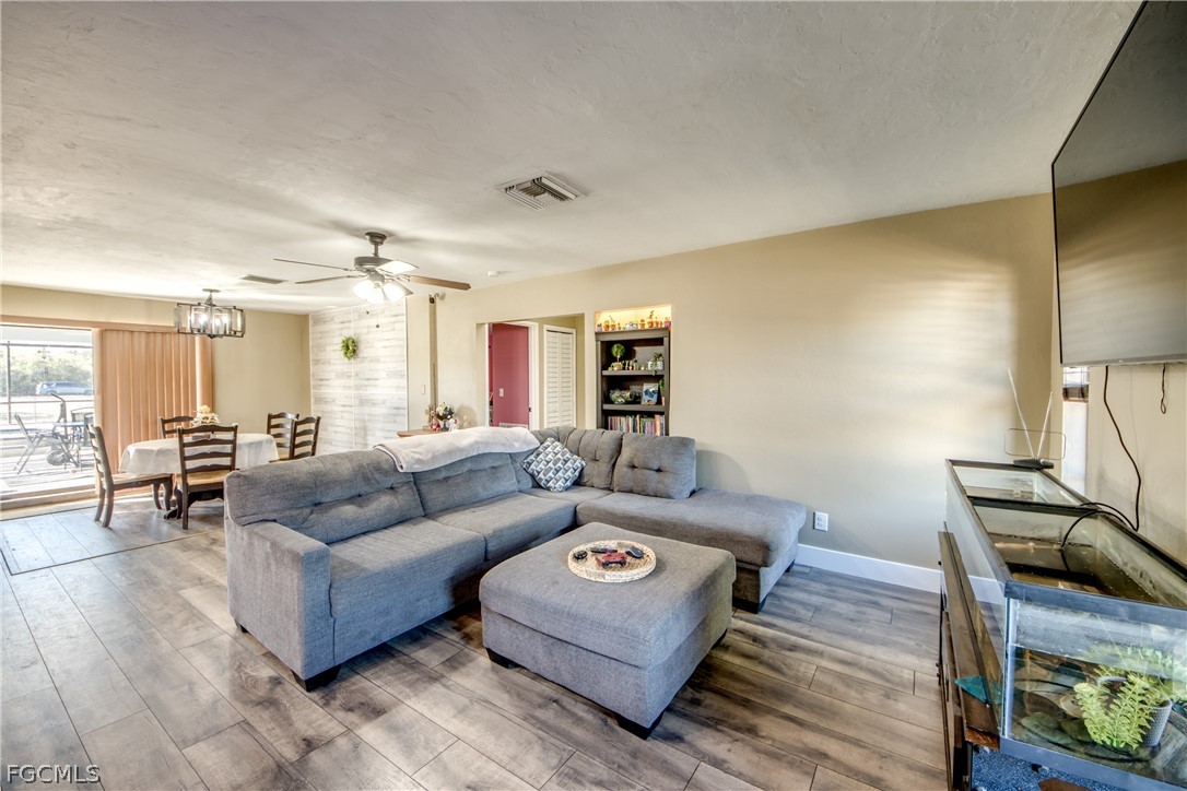 3015 8th Street Southwest Lehigh Acres, FL 33976 - Photo 7 of 34 a living room with furniture and a wooden floor