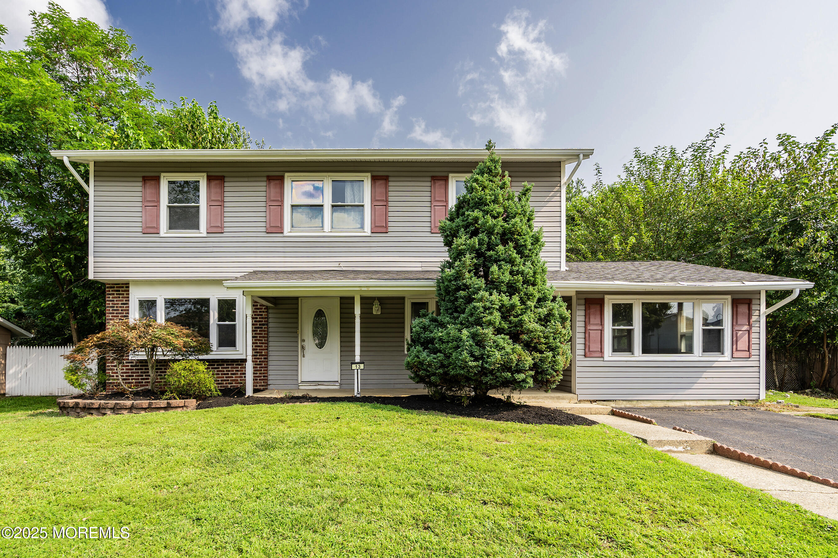 13 Rhode Island Drive Jackson, NJ 08527 - Photo 1 of 30 a front view of a house with a garden and plants