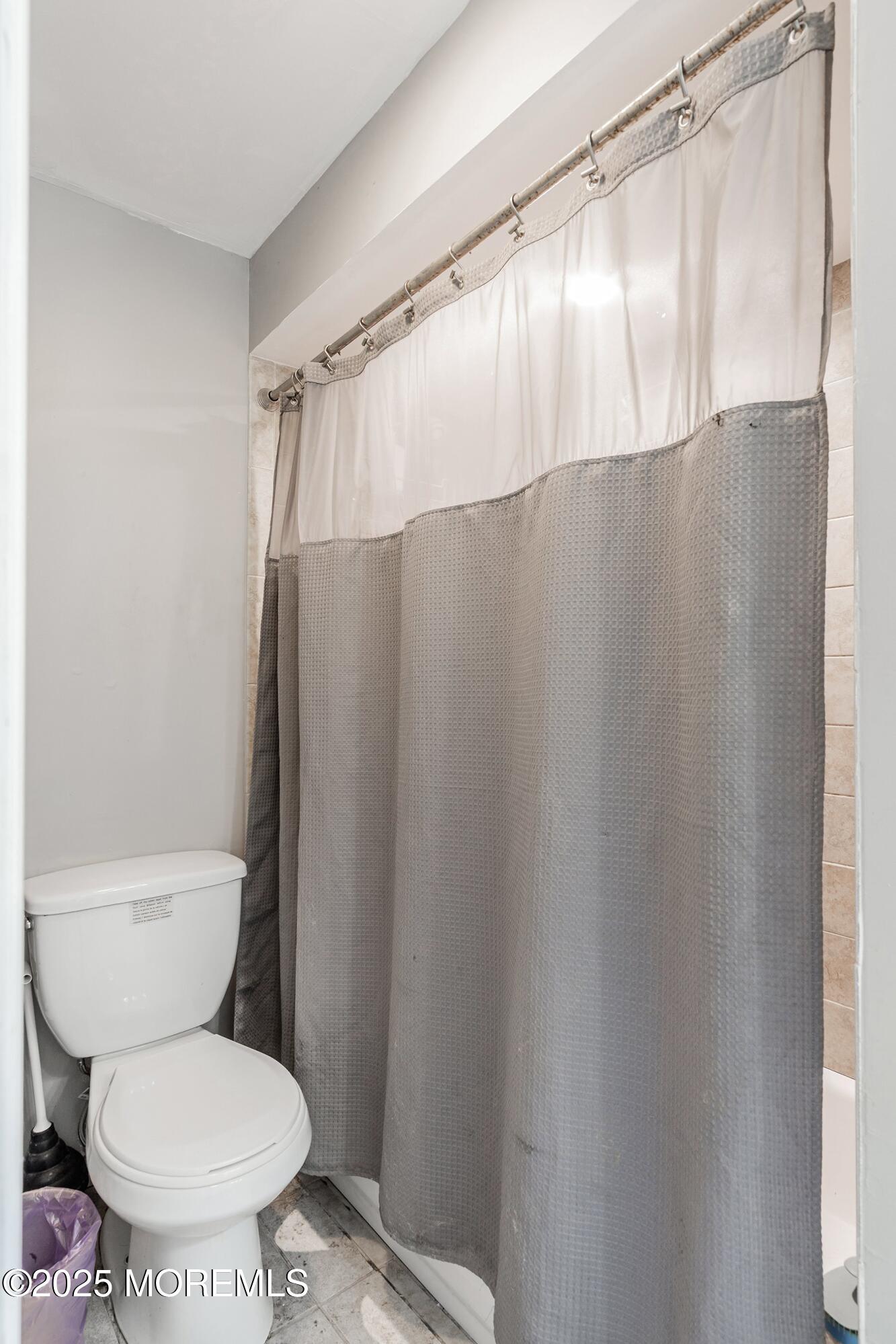 13 Rhode Island Drive Jackson, NJ 08527 - Photo 20 of 30 a white toilet sitting next to a shower curtain