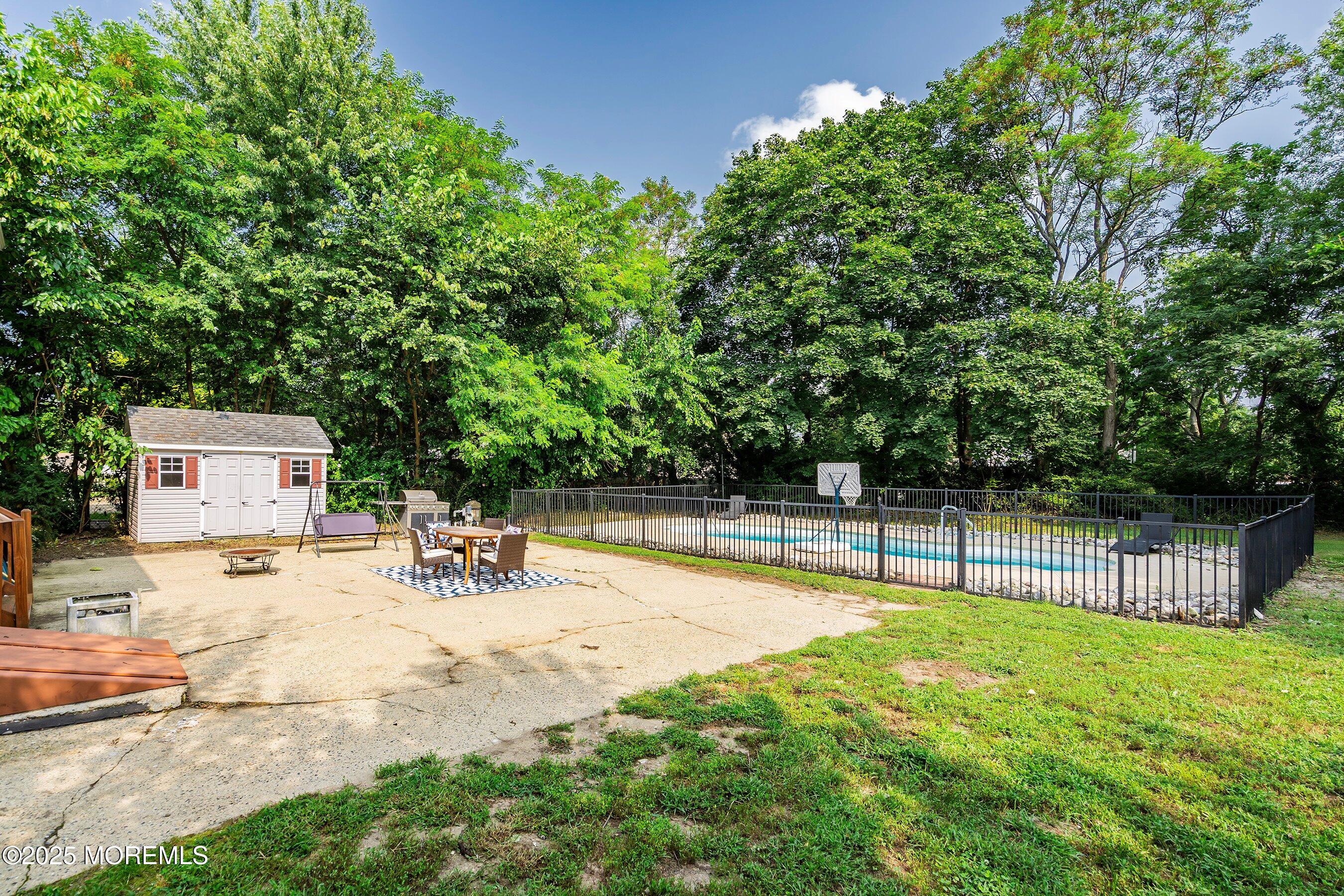 13 Rhode Island Drive Jackson, NJ 08527 - Photo 24 of 30 a view of a swimming pool with a bench and trees