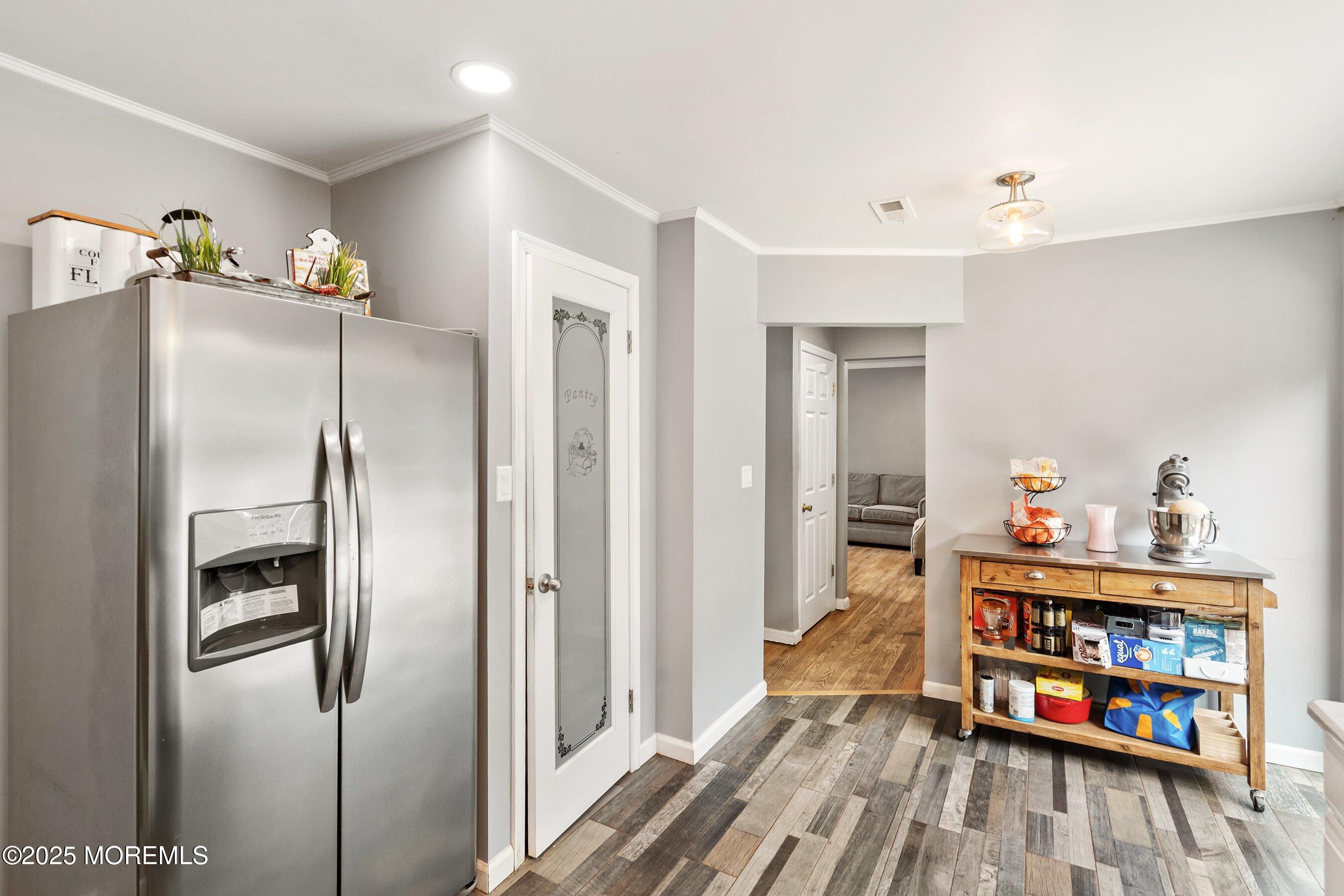 13 Rhode Island Drive Jackson, NJ 08527 - Photo 10 of 30 a kitchen with stainless steel appliances a refrigerator and a wooden floor