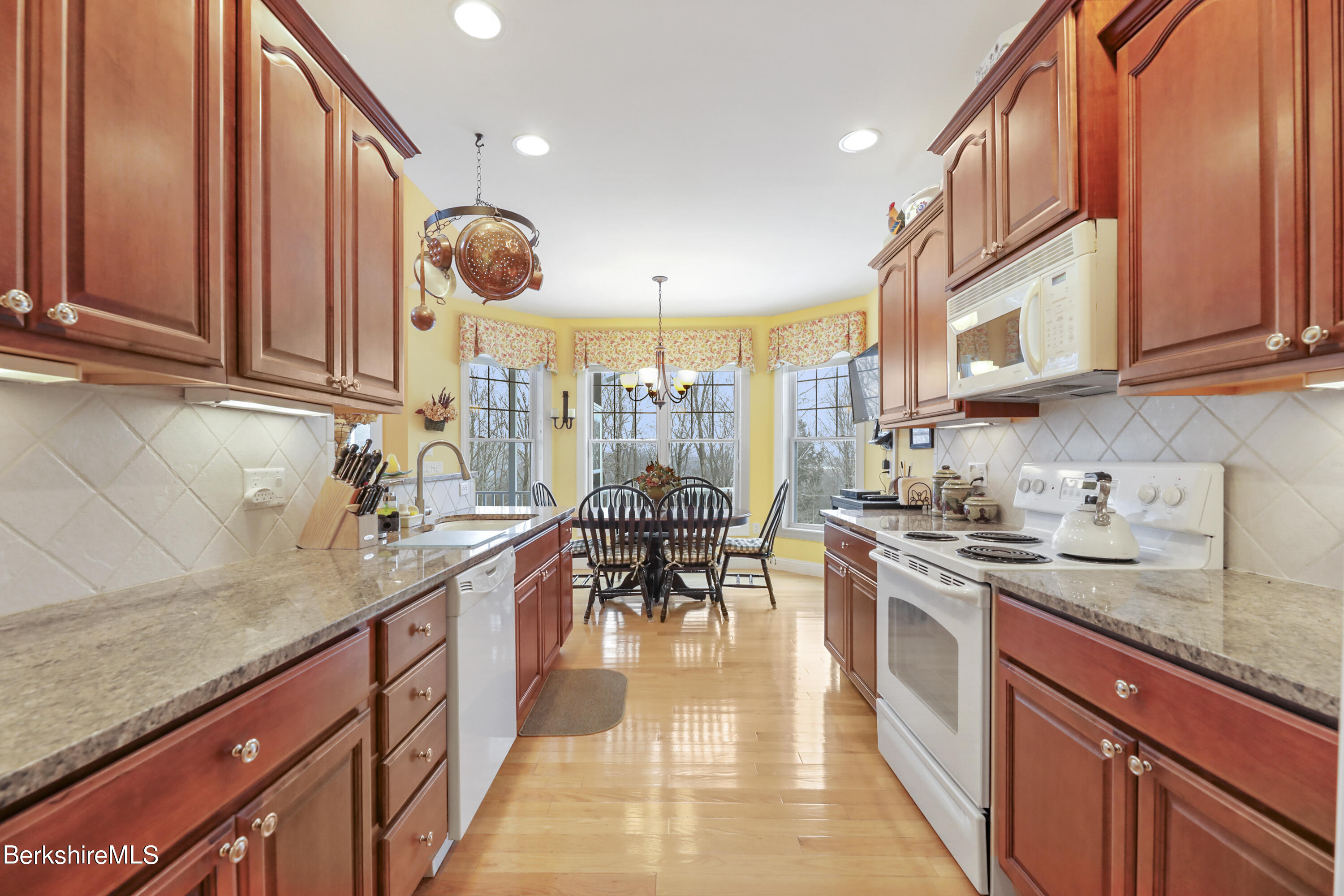 67 Alpine Trail Pittsfield, MA 01201 - Photo 11 of 40 a kitchen with stainless steel appliances granite countertop a stove a sink dishwasher and cabinets with wooden floor