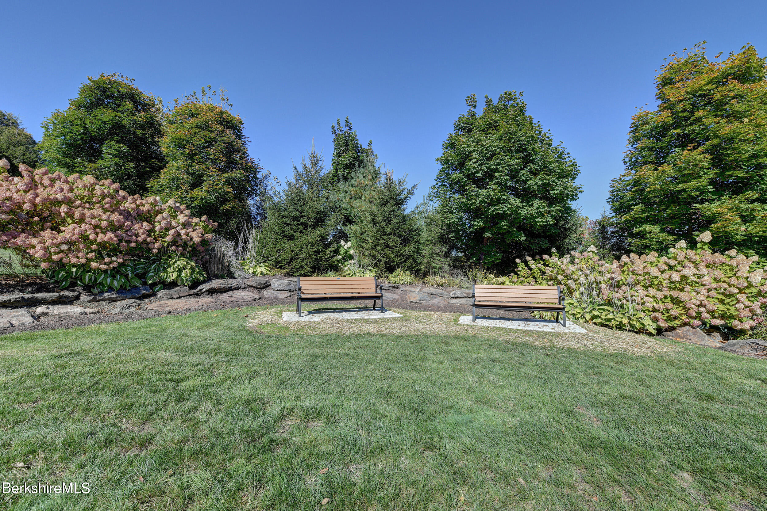 67 Alpine Trail Pittsfield, MA 01201 - Photo 37 of 40 a white house with a yard and sitting area