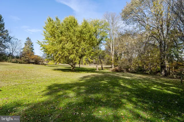 an aerial view of a house with a yard and lake view