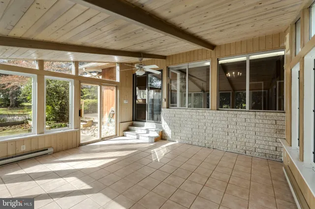 a view of a big room with windows and closet