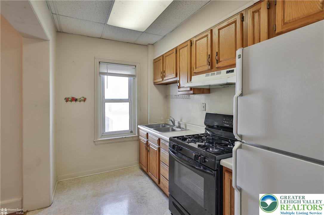 526 2nd Avenue Bethlehem, PA 18018 - Photo 22 of 40 a kitchen with stainless steel appliances granite countertop a stove and a refrigerator