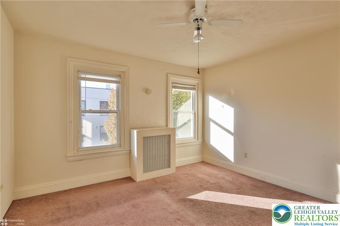 526 2nd Avenue Bethlehem, PA 18018 - Photo 25 of 40 an empty room with windows and ceiling fan