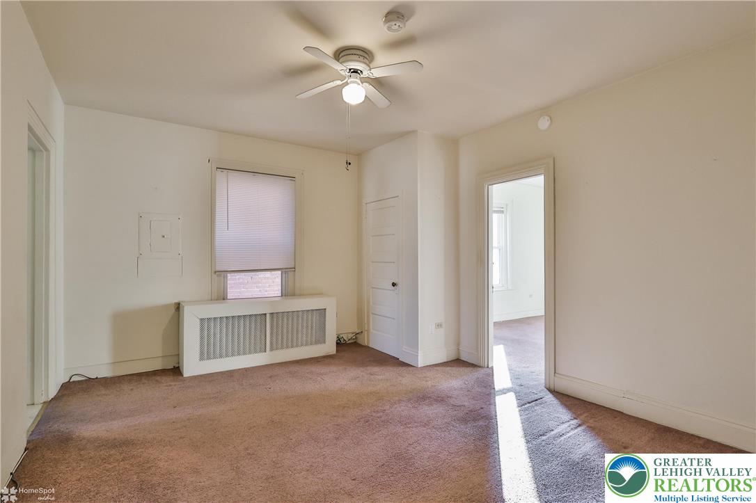 526 2nd Avenue Bethlehem, PA 18018 - Photo 28 of 40 an empty room with a ceiling fan and a window