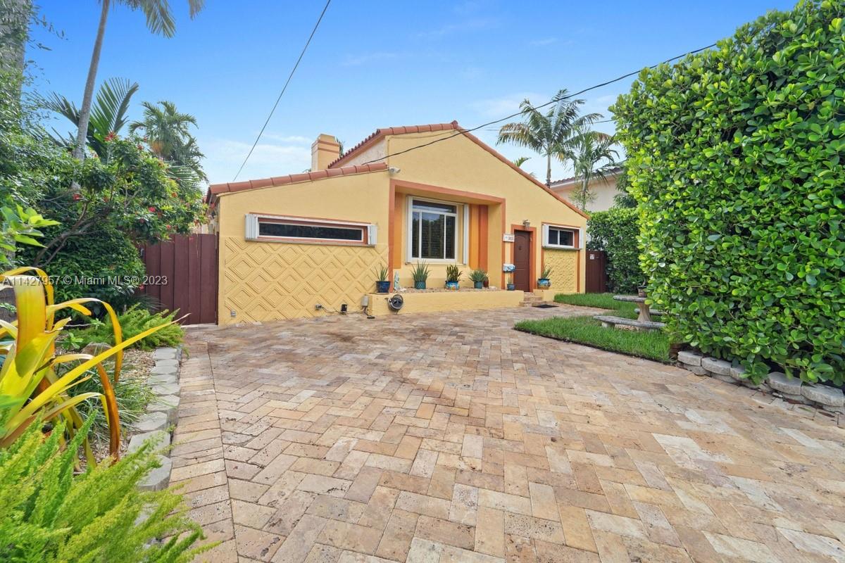 8925 Dickens Avenue Surfside, FL 33154 - Photo 1 of 1 a front view of house with yard and trees around