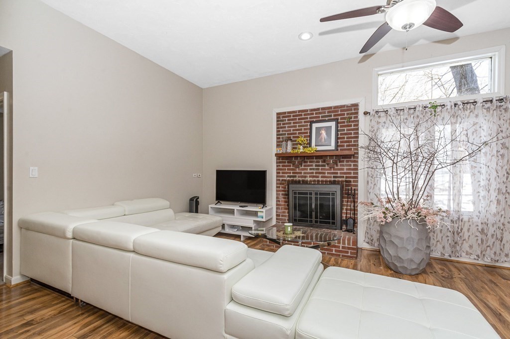 42 Epping Street, Unit 2 Lowell, MA 01852 - Photo 11 of 33 a living room with furniture a fireplace and a flat screen tv