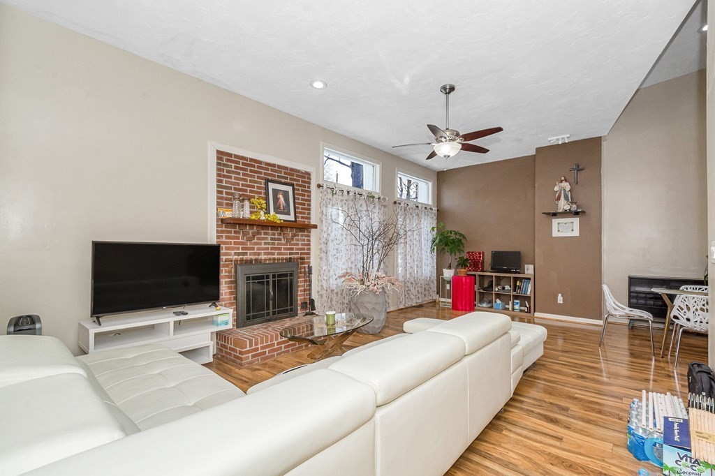 42 Epping Street, Unit 2 Lowell, MA 01852 - Photo 12 of 33 a living room with furniture flat screen tv and a fireplace