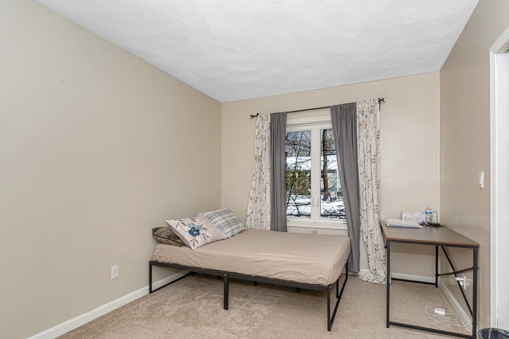 42 Epping Street, Unit 2 Lowell, MA 01852 - Photo 17 of 33 a living room with furniture and a table