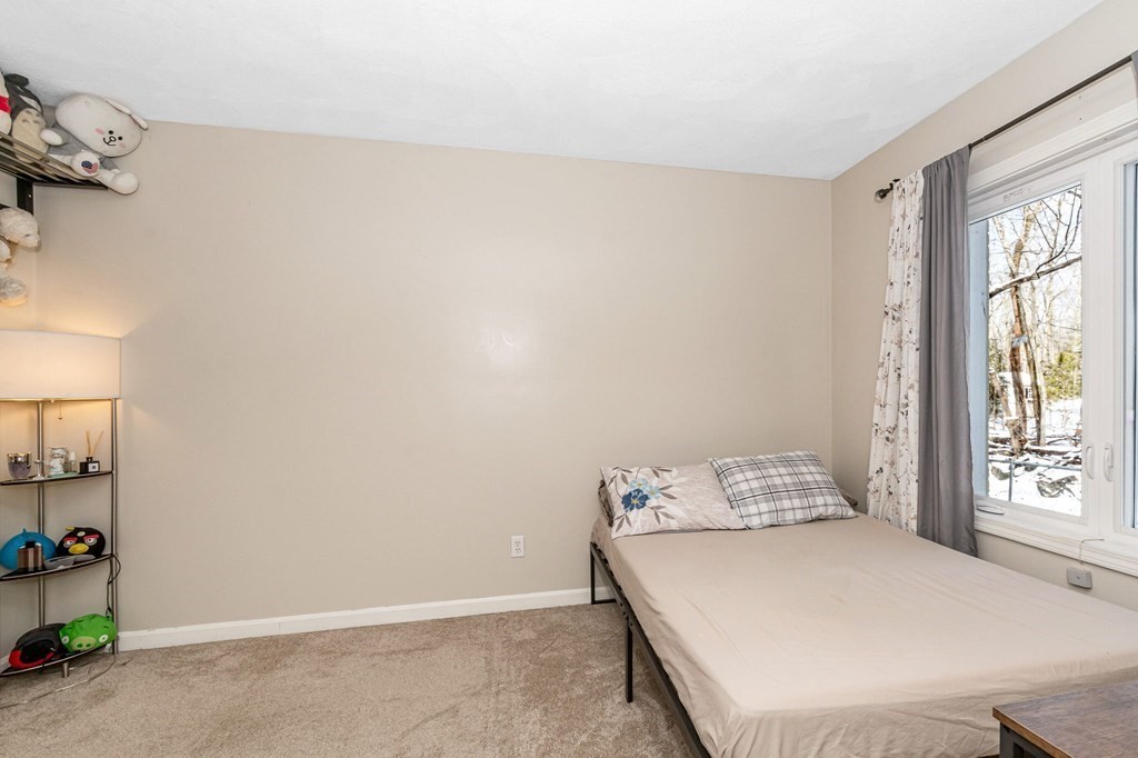 42 Epping Street, Unit 2 Lowell, MA 01852 - Photo 19 of 33 a bed sitting in a bedroom next to a window