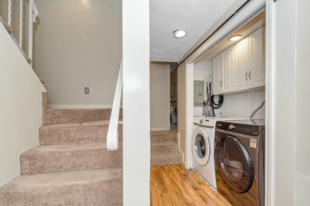 42 Epping Street, Unit 2 Lowell, MA 01852 - Photo 20 of 33 a view of washer and dryer with kitchen in the background