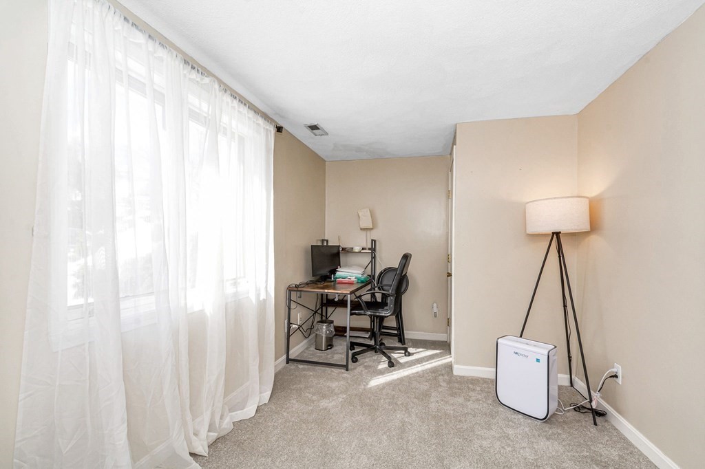 42 Epping Street, Unit 2 Lowell, MA 01852 - Photo 22 of 33 a room with furniture and a chandelier