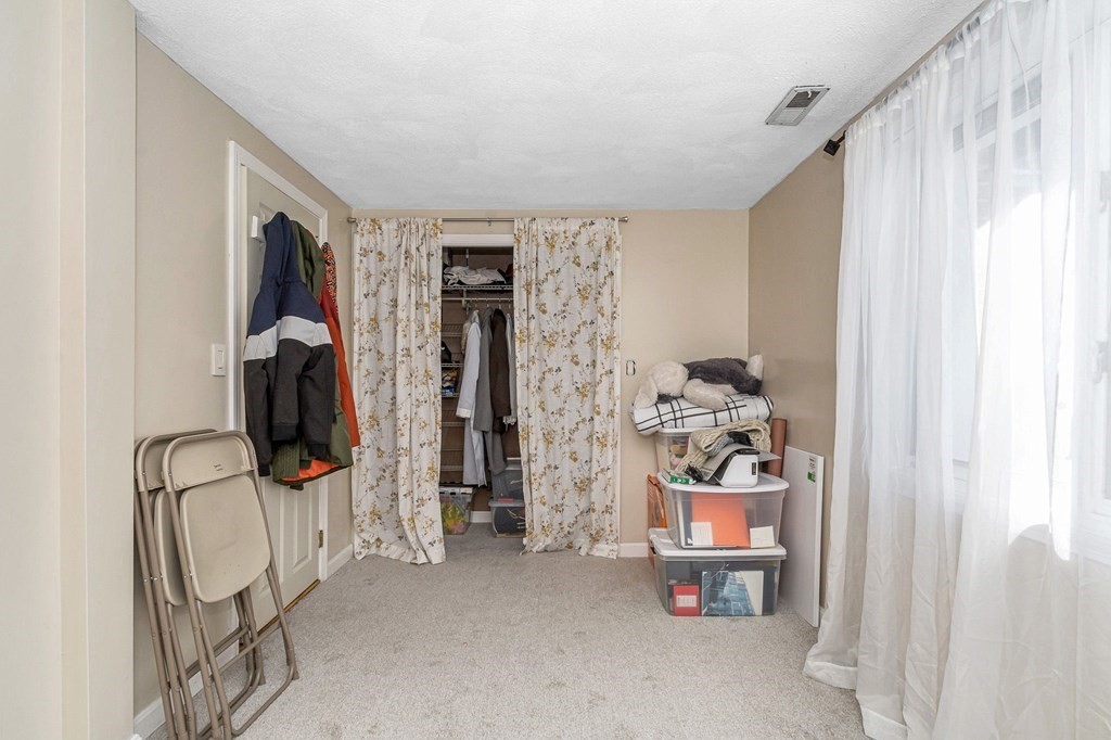 42 Epping Street, Unit 2 Lowell, MA 01852 - Photo 23 of 33 walk in closet with window and book shelf