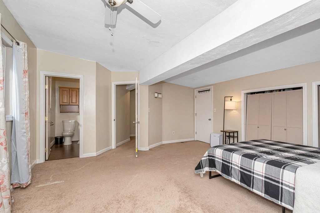 42 Epping Street, Unit 2 Lowell, MA 01852 - Photo 26 of 33 a bedroom with a bed and a cabinets