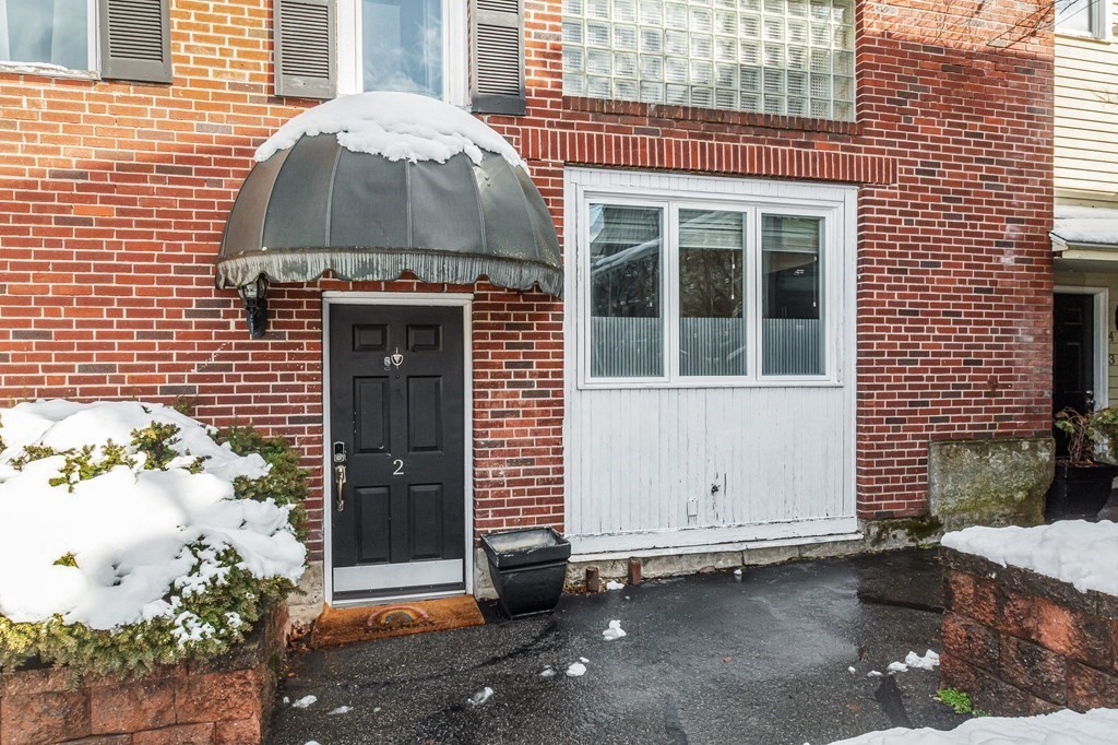 42 Epping Street, Unit 2 Lowell, MA 01852 - Photo 31 of 33 a front view of a house with a garage