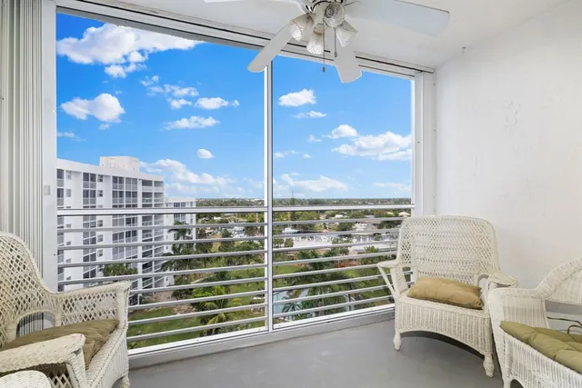 a view of a living room with furniture and a chandelier