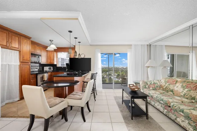a living room with furniture a flat screen tv and a large window