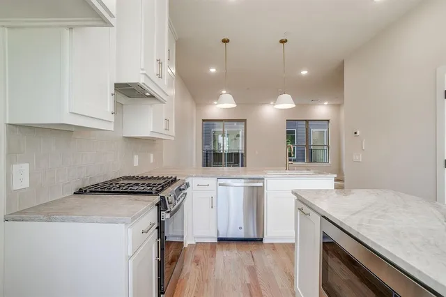 a kitchen with a sink stove and cabinets