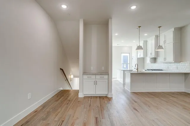 a view of kitchen with wooden floor and electronic appliances
