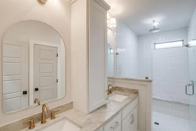 a bathroom with a granite countertop sink mirror and double