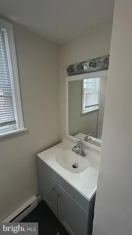 a bathroom with a sink and a window