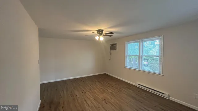 wooden floor in an empty room with a window