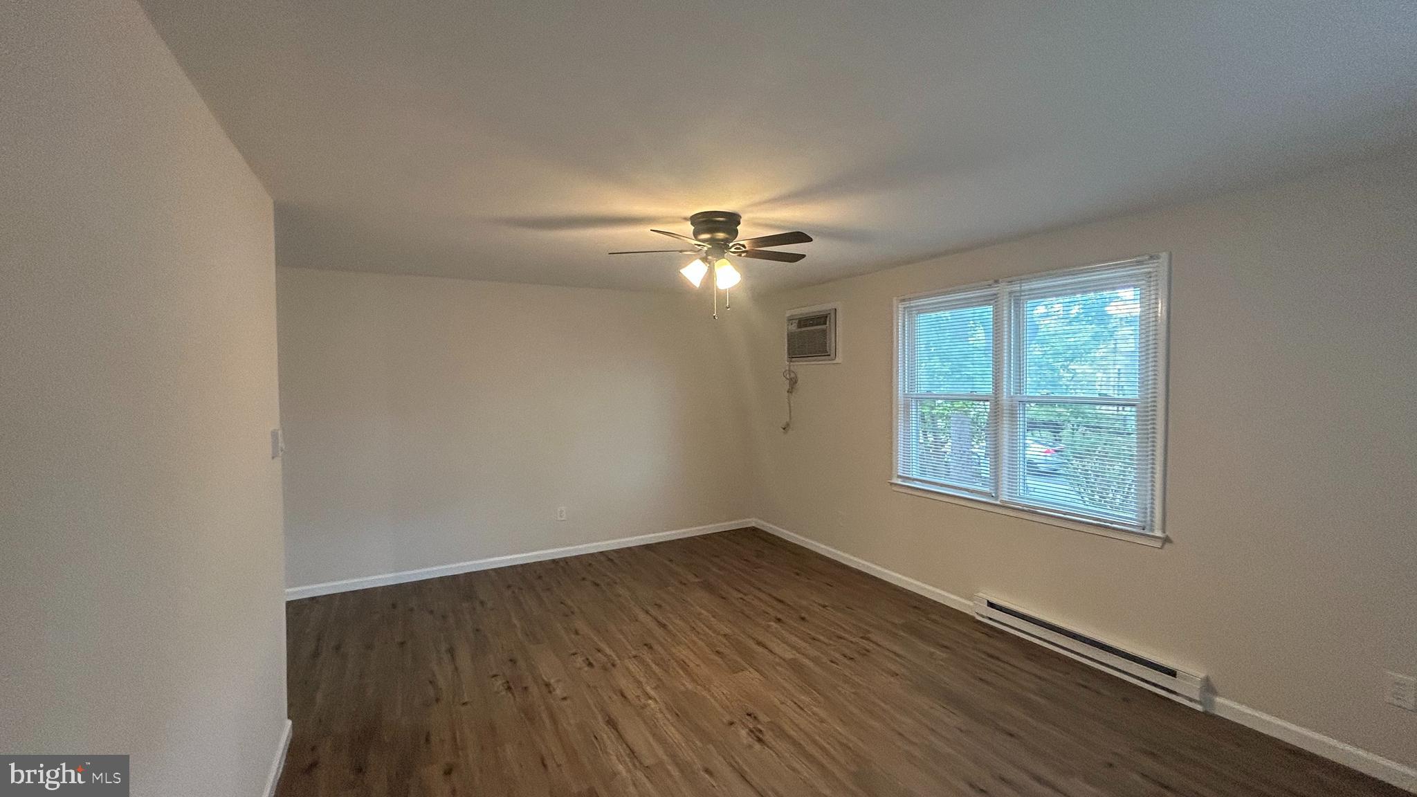 1022 Fox Chase Road, Unit B Jenkintown, PA 19046 - Photo 4 of 18 wooden floor in an empty room with a window