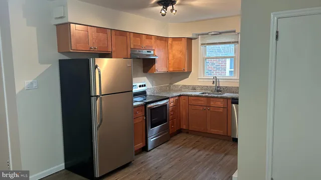a kitchen with a refrigerator sink and cabinets