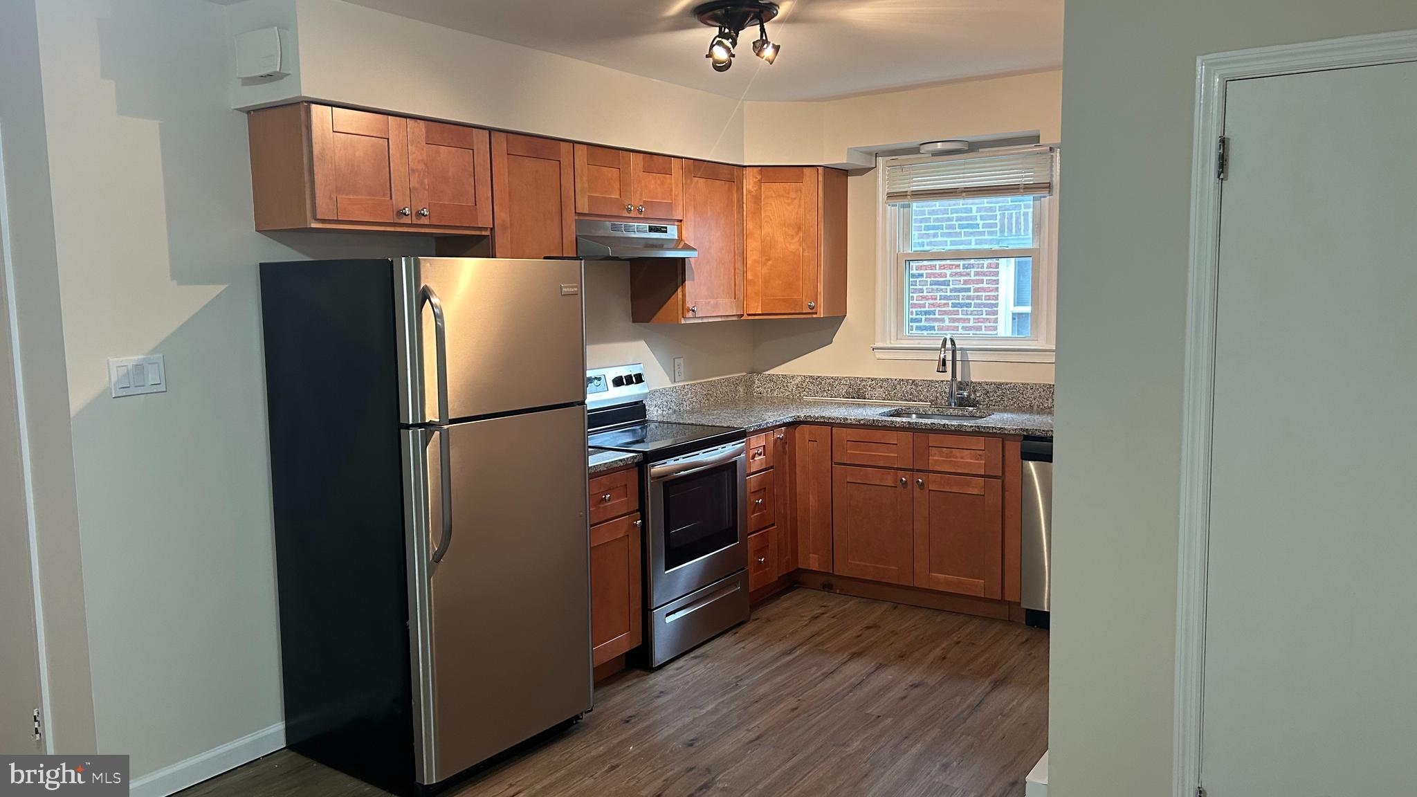 1022 Fox Chase Road, Unit B Jenkintown, PA 19046 - Photo 6 of 18 a kitchen with a refrigerator sink and cabinets
