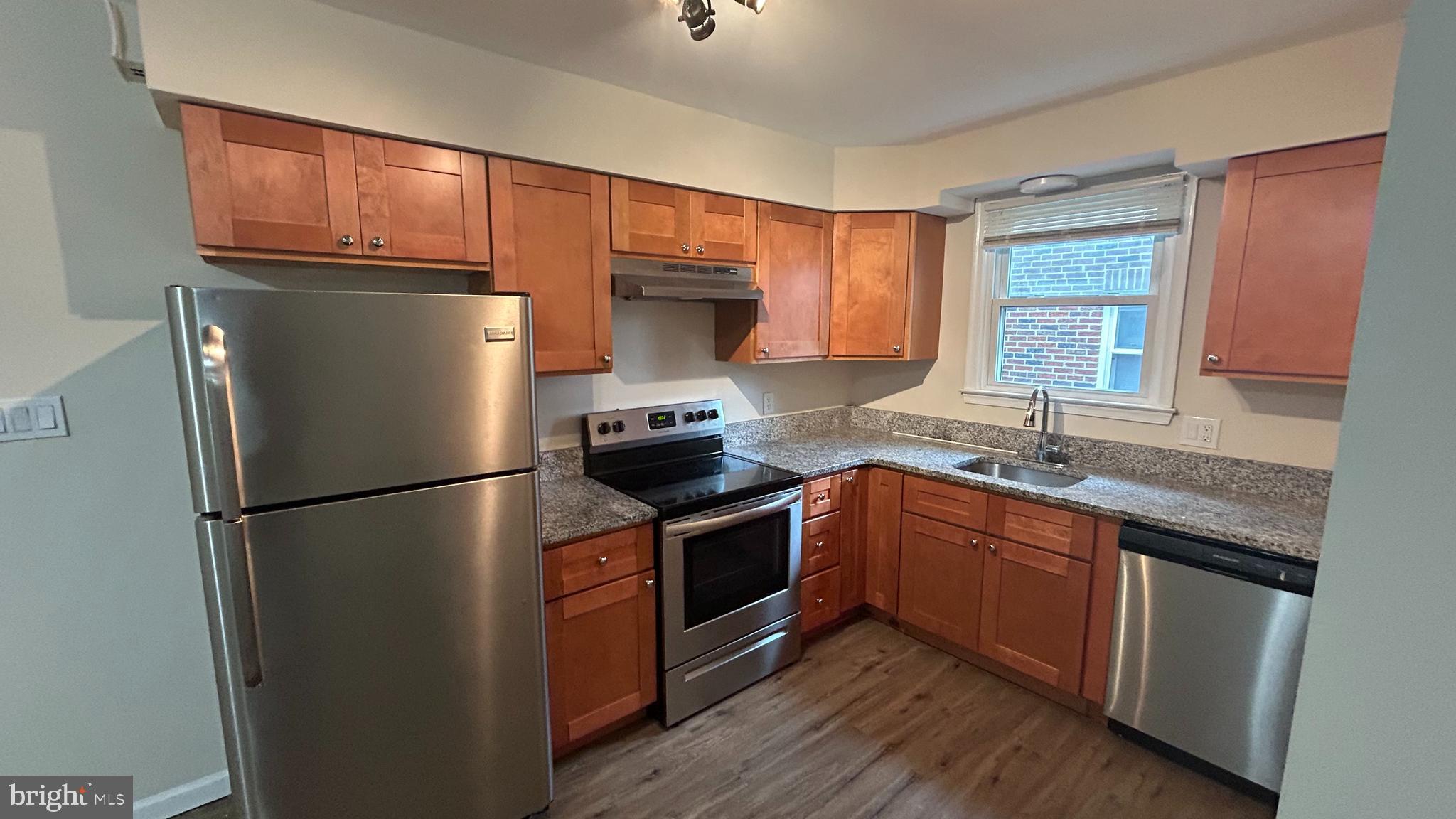 1022 Fox Chase Road, Unit B Jenkintown, PA 19046 - Photo 7 of 18 a kitchen with stainless steel appliances a refrigerator sink and cabinets