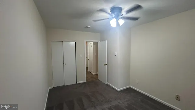 a view of an empty room with a fan