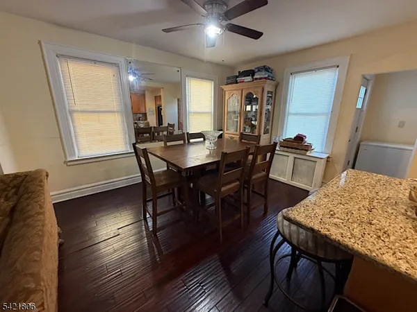 a view of a a dining room with furniture window and wooden floor