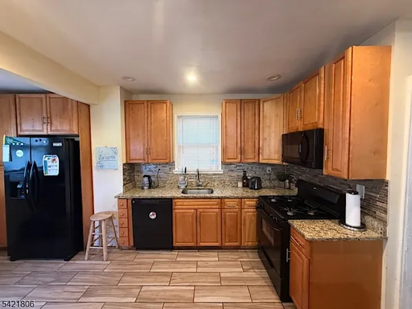 a kitchen with a sink stove and refrigerator