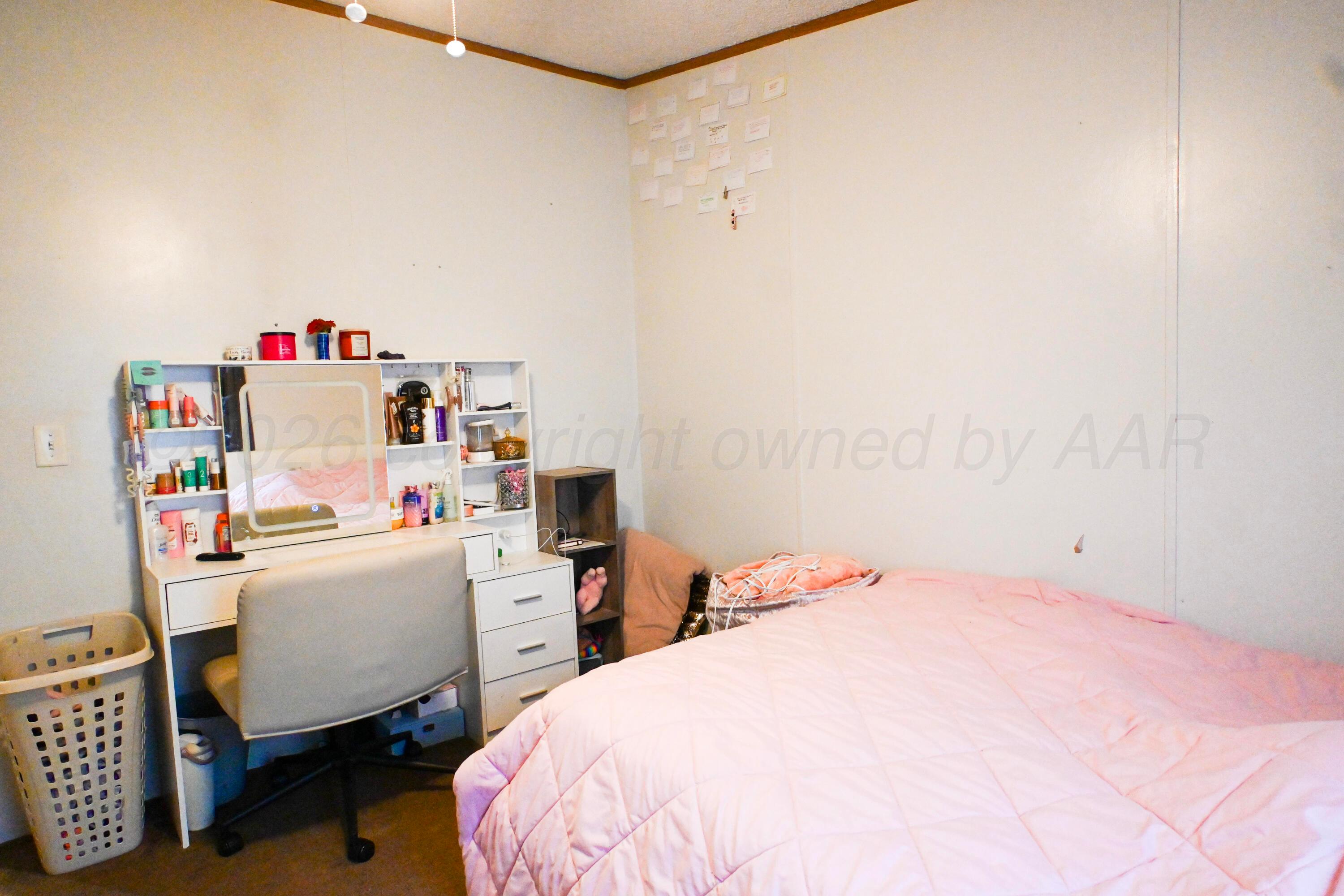 314 Cactus Road Borger, TX 79007 - Photo 13 of 28 a bedroom with a bed and a window