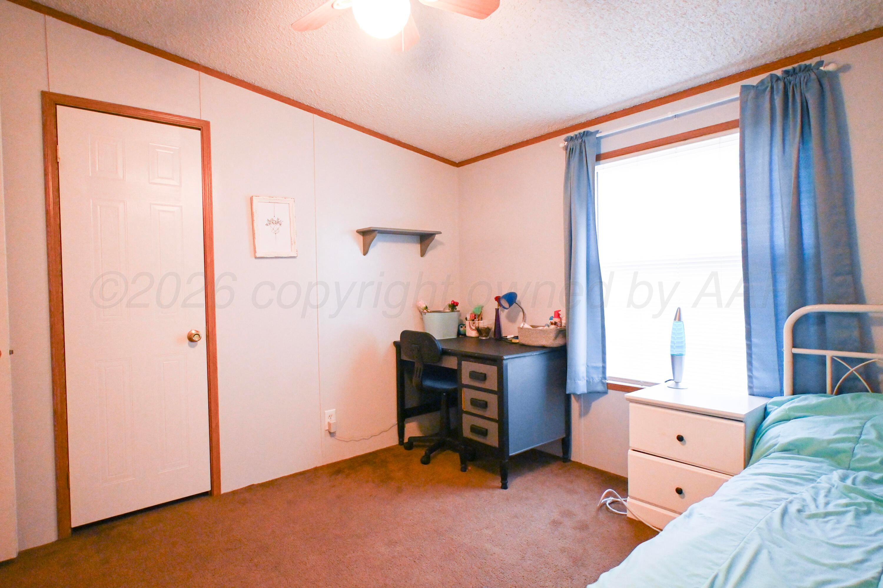 314 Cactus Road Borger, TX 79007 - Photo 15 of 28 a bedroom with a bed and a window